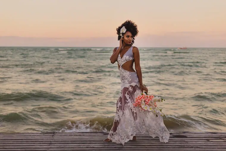 black bride with natural wedding hairstyle on beach 