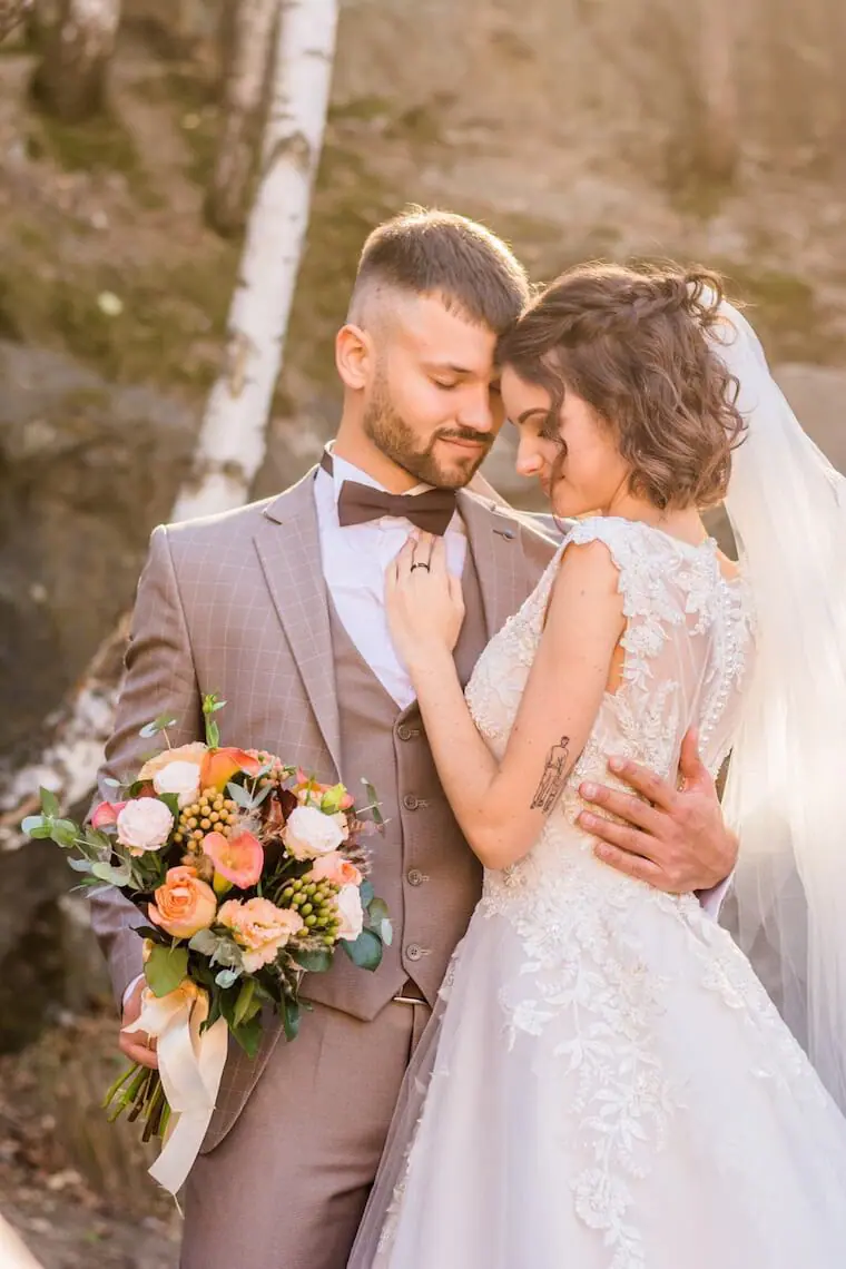 bride and groom holding bouqet of flowers