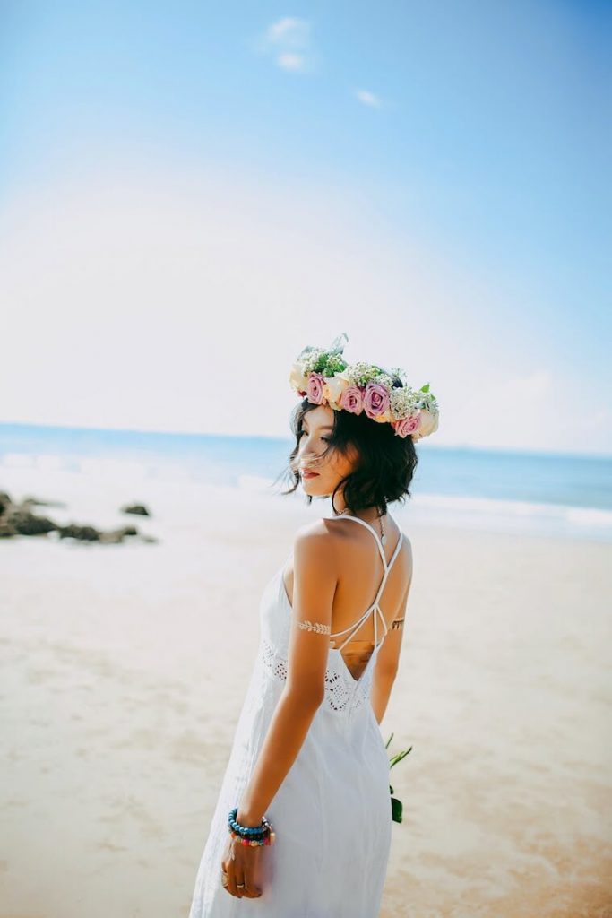 bride wearing flower crown on beach 
