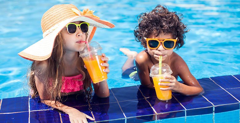 kids sipping drinks in the pool 