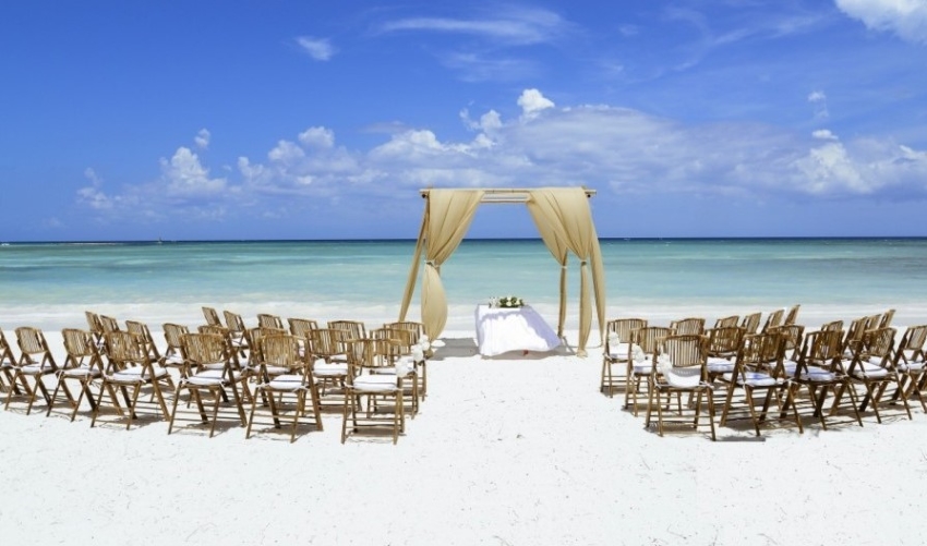 beach wedding setup at barcelo maya palace resort