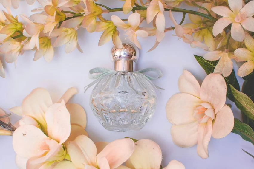 perfume bottle surrounded by flowers