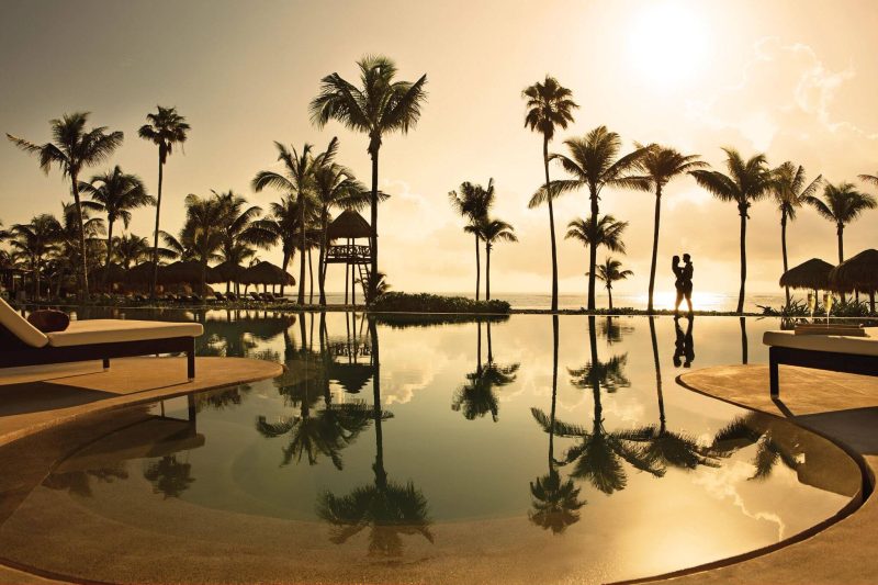 secret akumal riviera maya infinity pool couple sunset