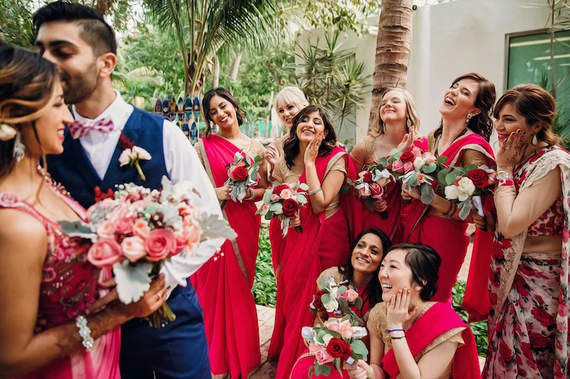 guests admiring bride and groom kissing