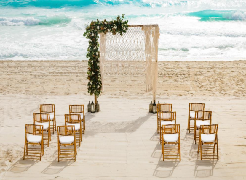 Wedding arch and guest chairs on the beach at Paradisus Cancun