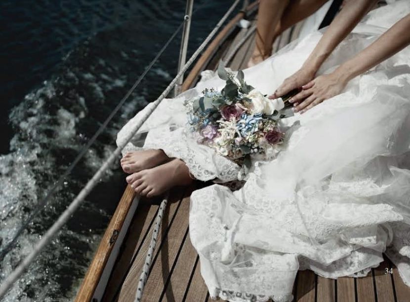 Bride with bouquet on a catamaran at the All Aboard venue Paradisus Cancun