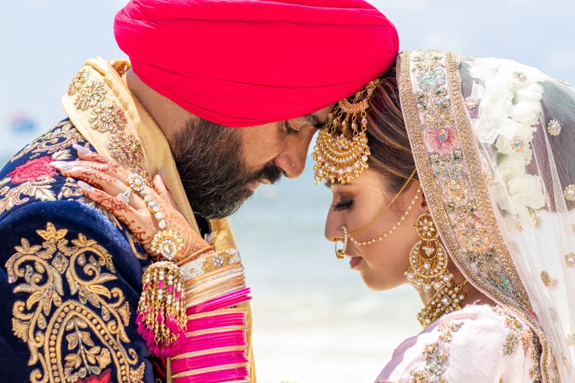 sikh bride and groom on the beach