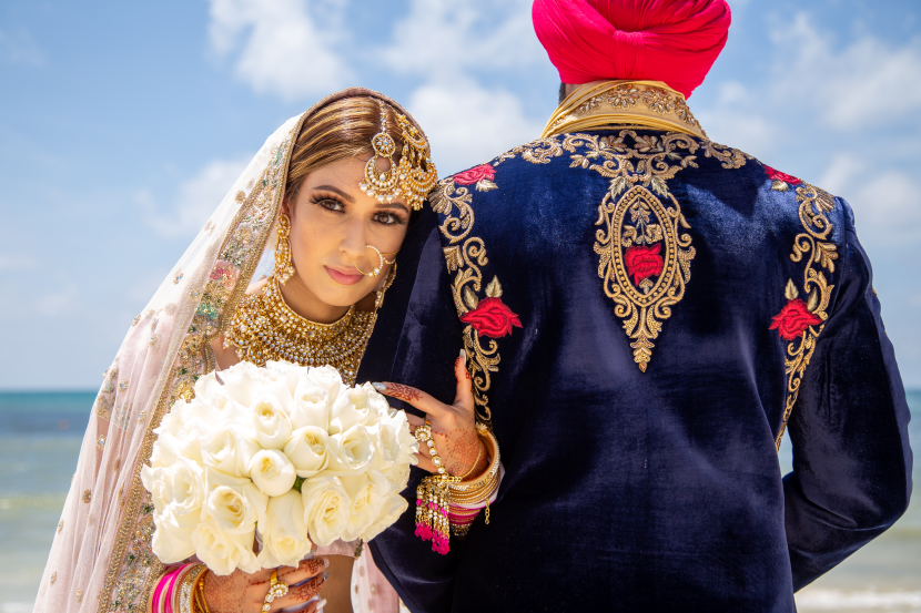 Sikh bride and groom on a beach