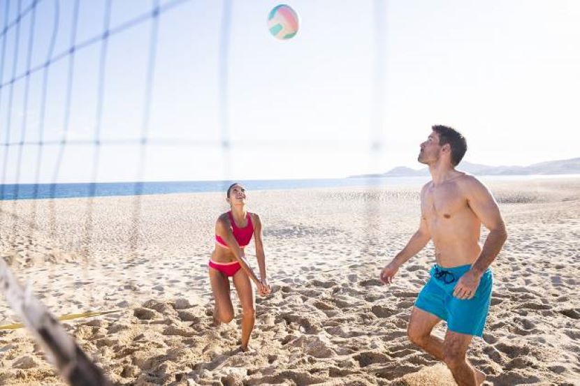 couple playing volleyball on beach at Hyatt Ziva Los Cabos
