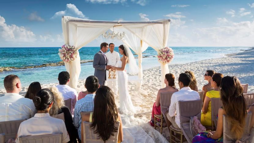 couple getting married on beach at El Dorado Casitas Royale