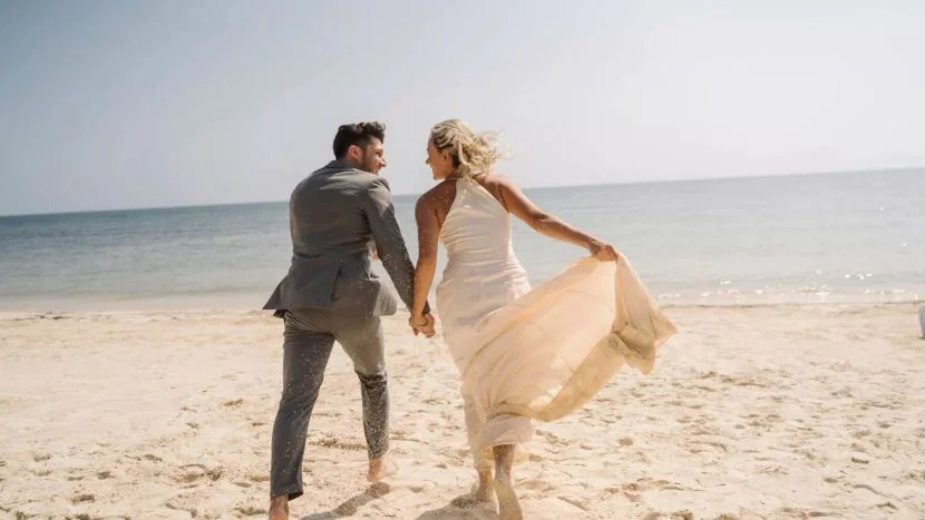 bride and groom on beach at El Dorado Royale