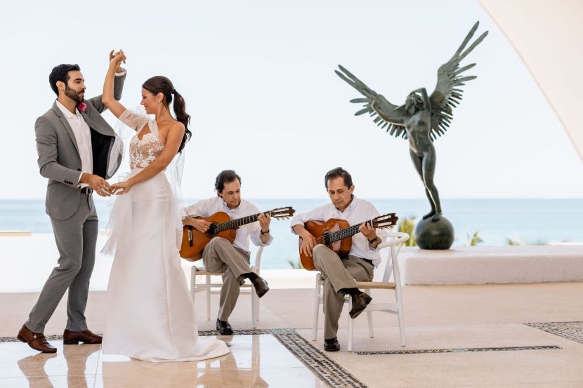 bride and groom dancing while a mariachi band plays at Marquis Los Cabos
