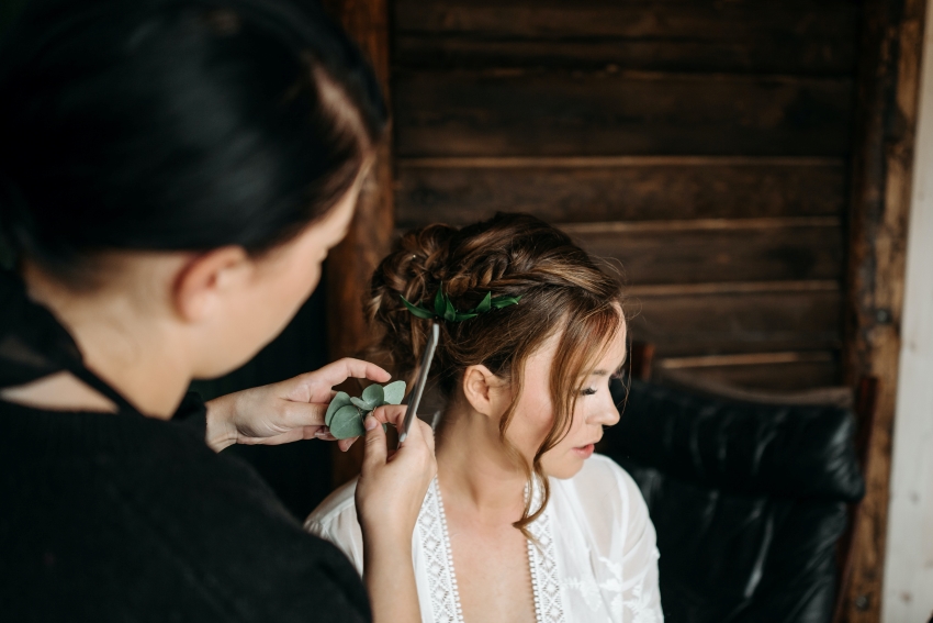 hairstylist working on bride's hair