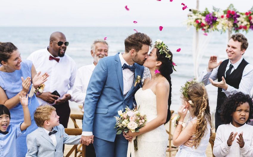 destination wedding couple on beach kissing