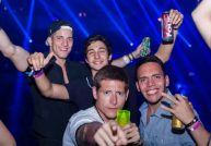men in a club holding beers
