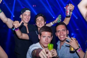 men in a club holding beers