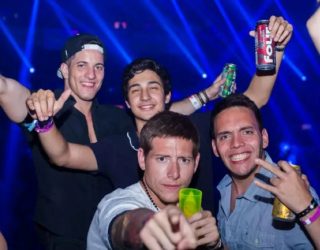 men in a club holding beers