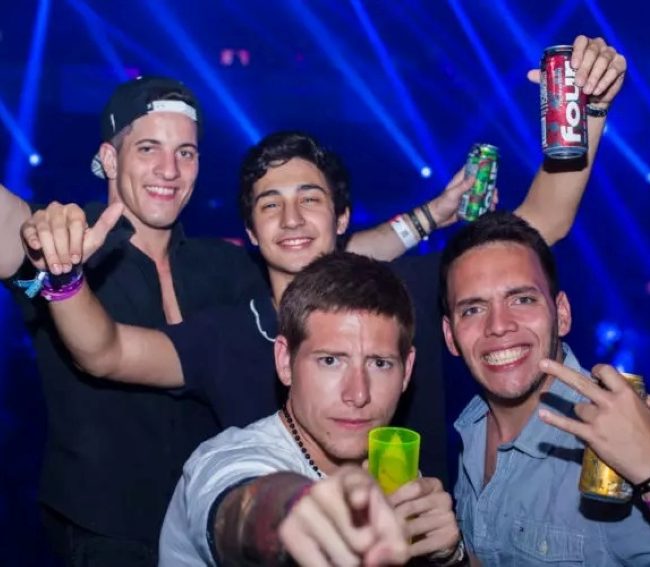 men in a club holding beers