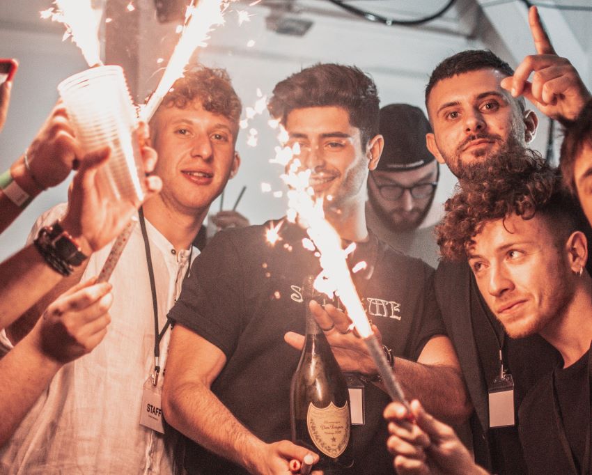 group of men with sparklers and booze