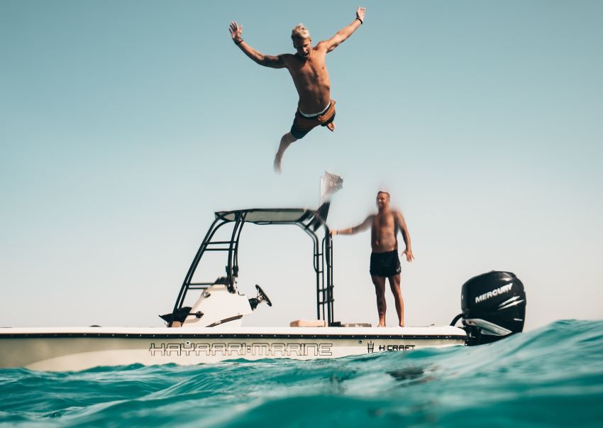 man jumping off a yacht into the sea