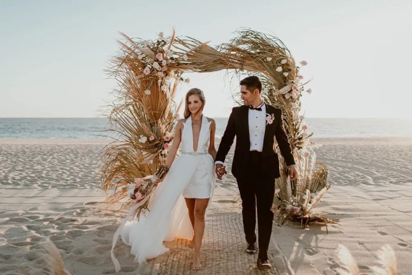 bride and groom on the beach at nobu hotel los cabos