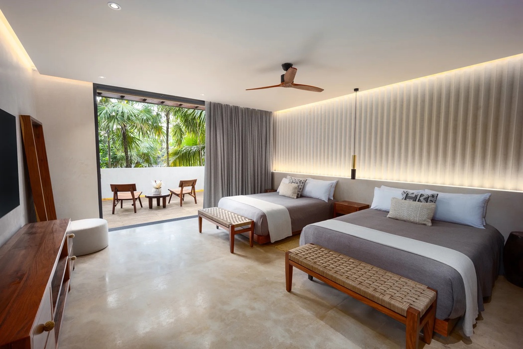 bedroom with double beds at secrets tulum