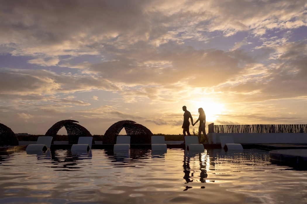 couple at the rooftop pool at secrets tulum