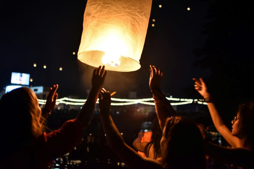 people releasing sky lanterns