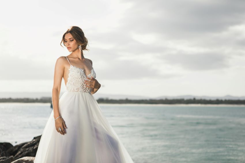 bride standing against the backdrop of a sea