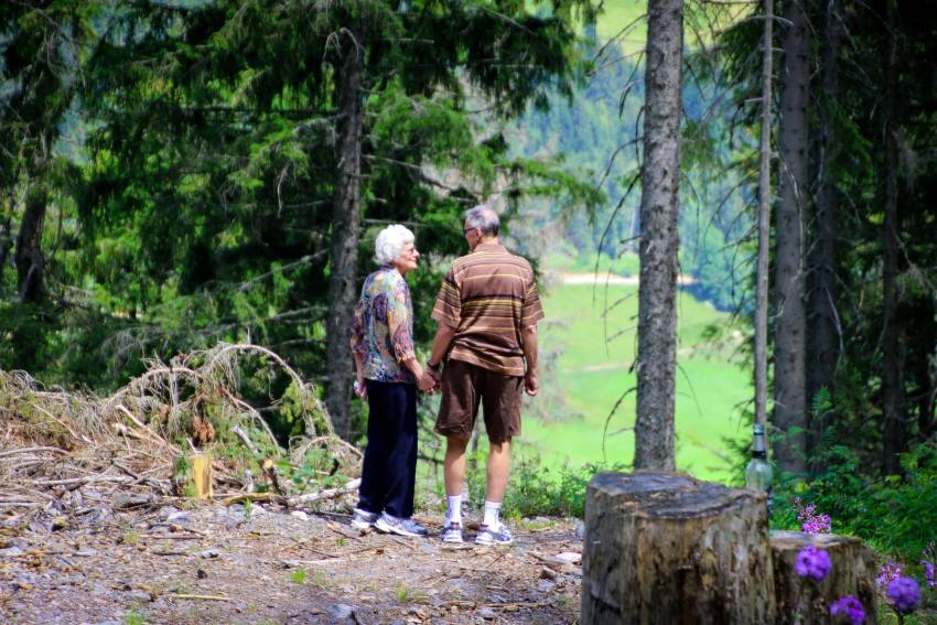 old couple travelling exploring a forest