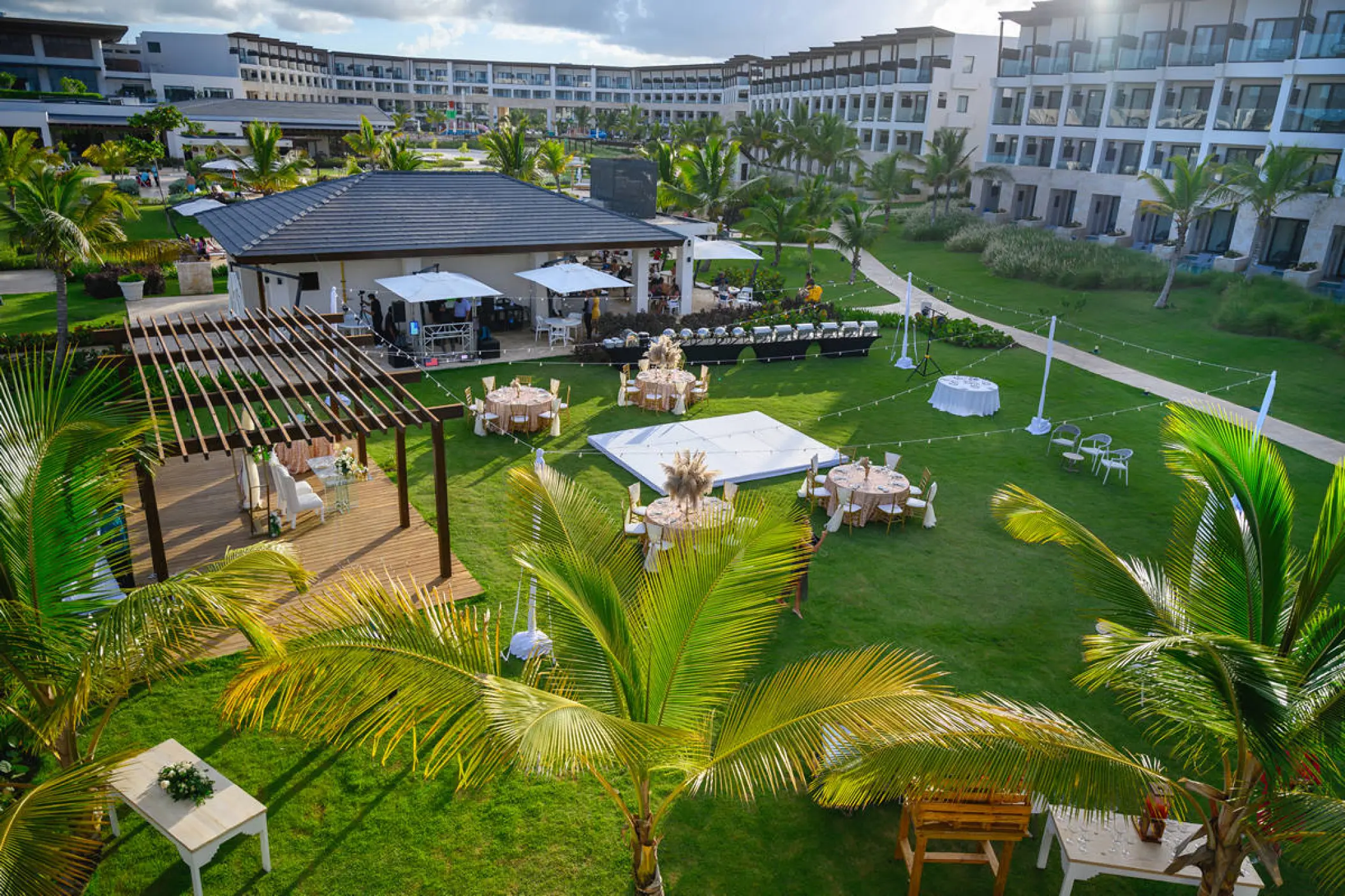 Garden wedding reception setup with dance floor and round tables at Dreams Macao Beach, Punta Cana