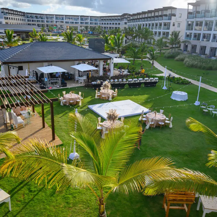 Garden wedding reception setup with dance floor and round tables at Dreams Macao Beach, Punta Cana