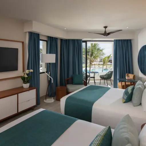 Junior suite with two double beds and a private balcony at Dreams Macao Beach, Punta Cana