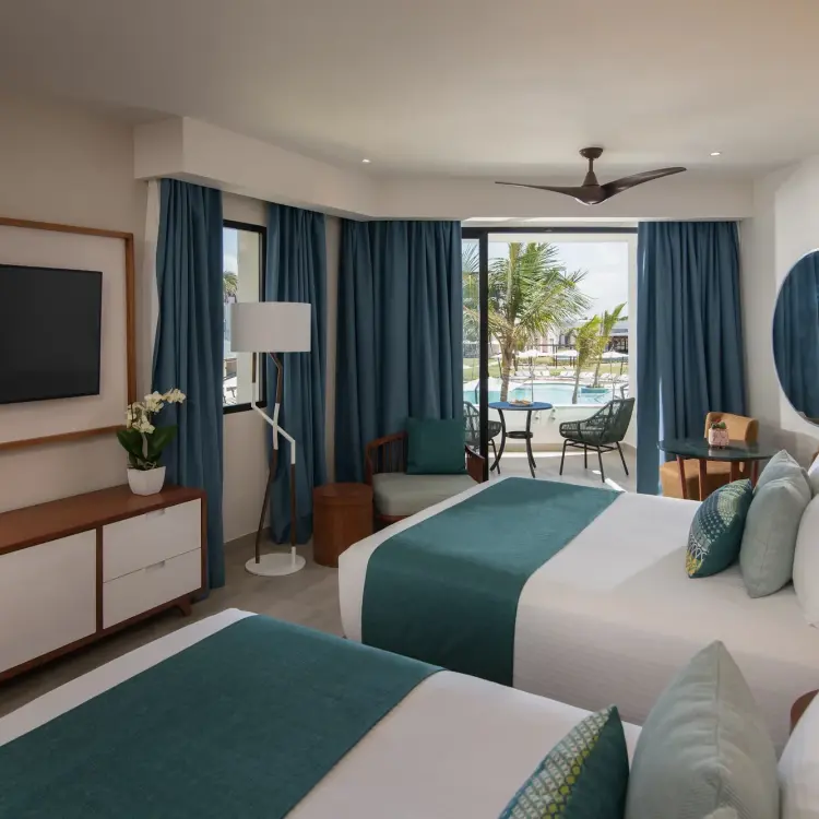 Junior suite with two double beds and a private balcony at Dreams Macao Beach, Punta Cana
