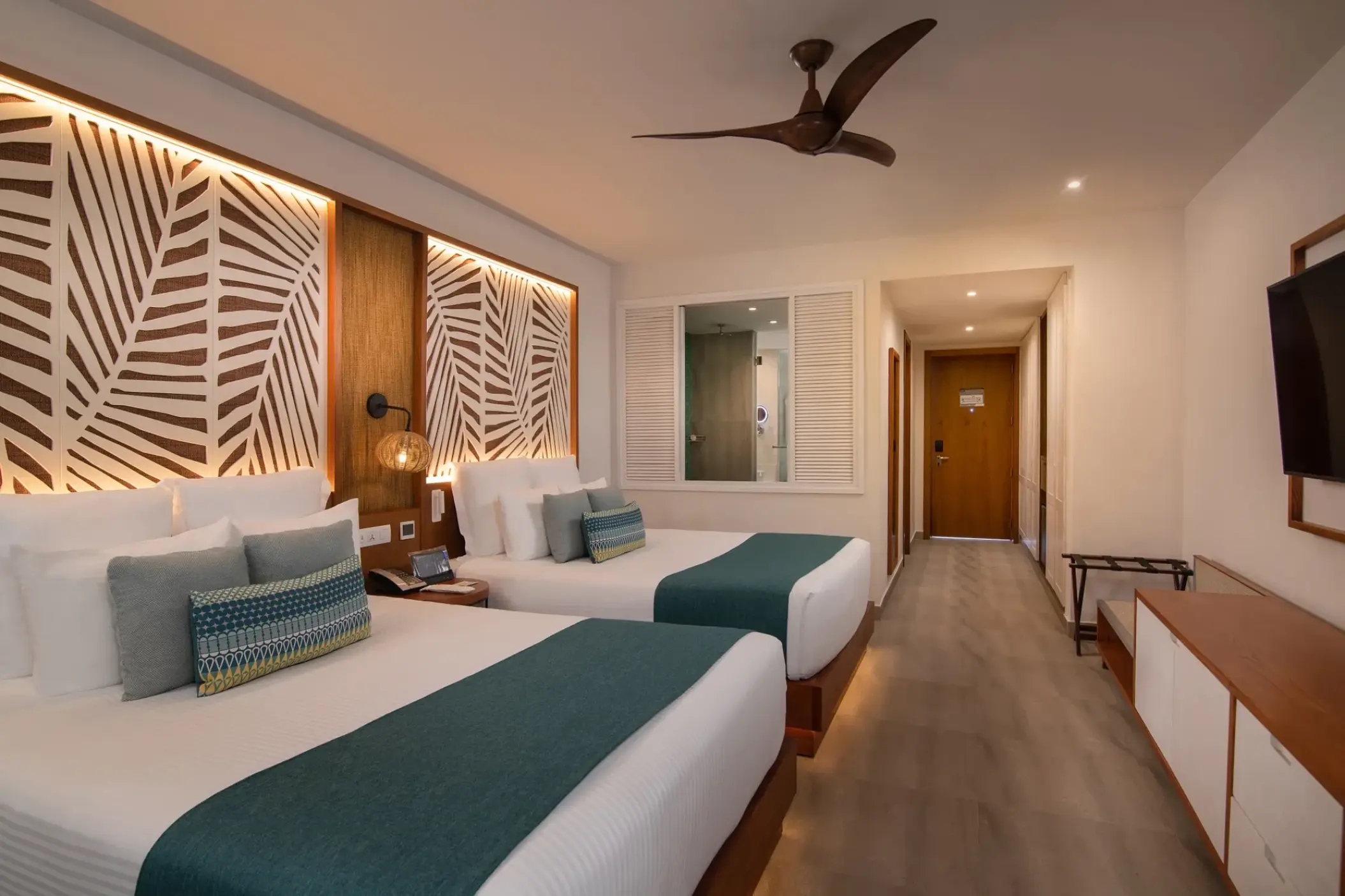 Junior Suite with two double beds and tropical wall art at Dreams Macao Beach, Punta Cana