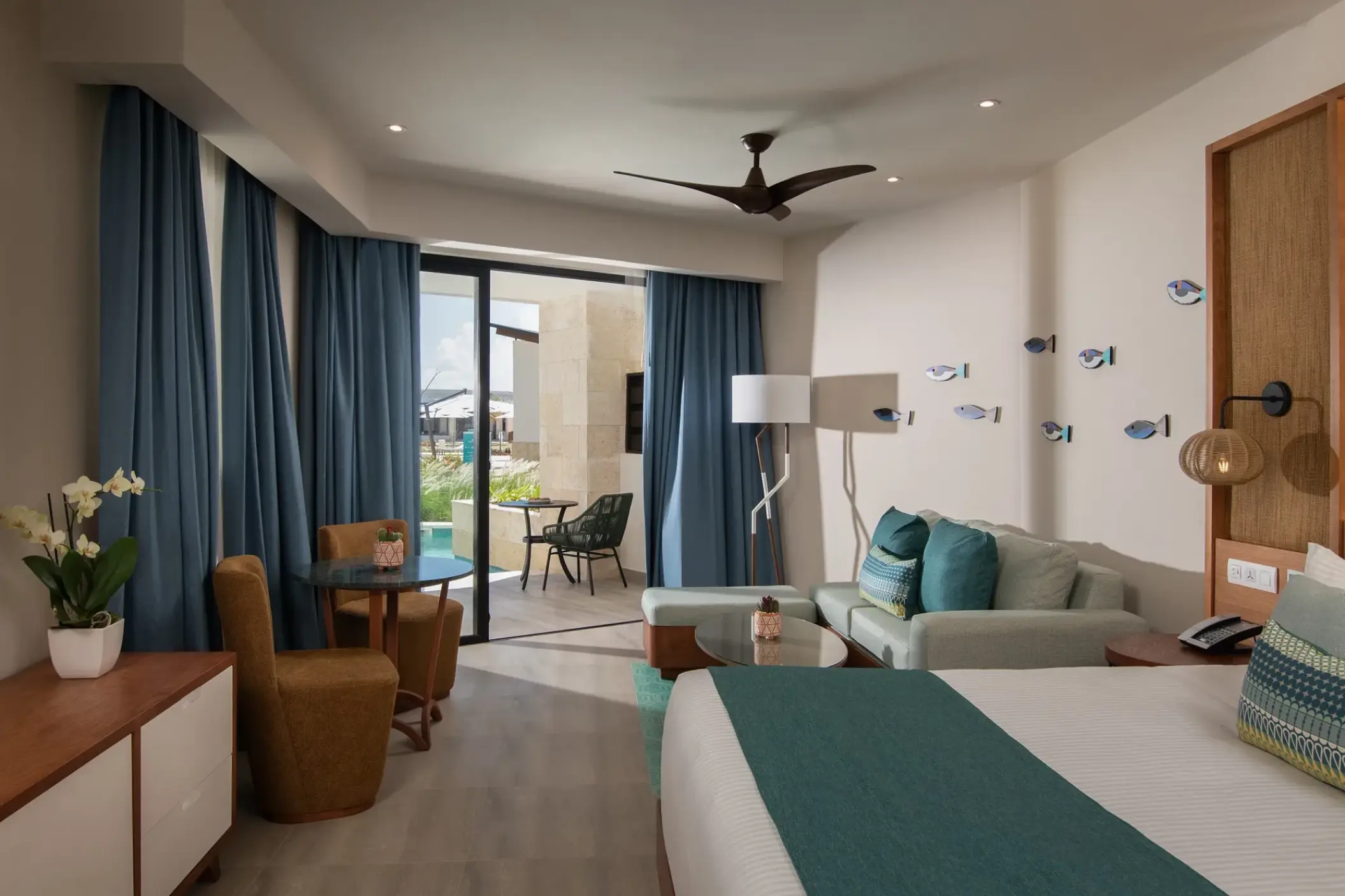 Junior Suite interior with teal accents and balcony at Dreams Macao Beach, Punta Cana