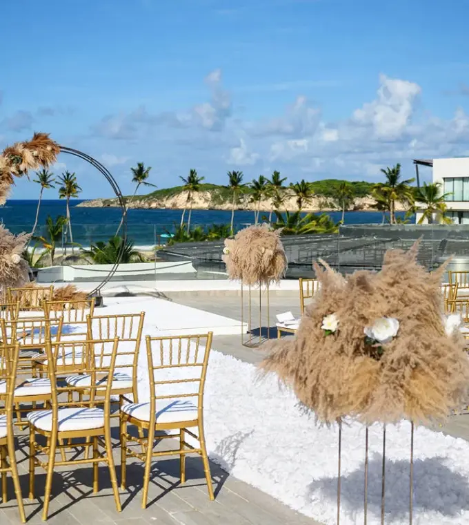 Rooftop wedding ceremony with gold chairs and pampas grass at Dreams Macao Beach, Punta Cana