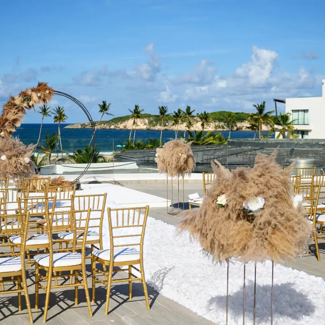 Rooftop wedding ceremony with gold chairs and pampas grass at Dreams Macao Beach, Punta Cana