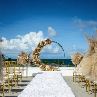 Rooftop wedding ceremony with pampas grass decor and circular arch at Dreams Macao Beach, Punta Cana