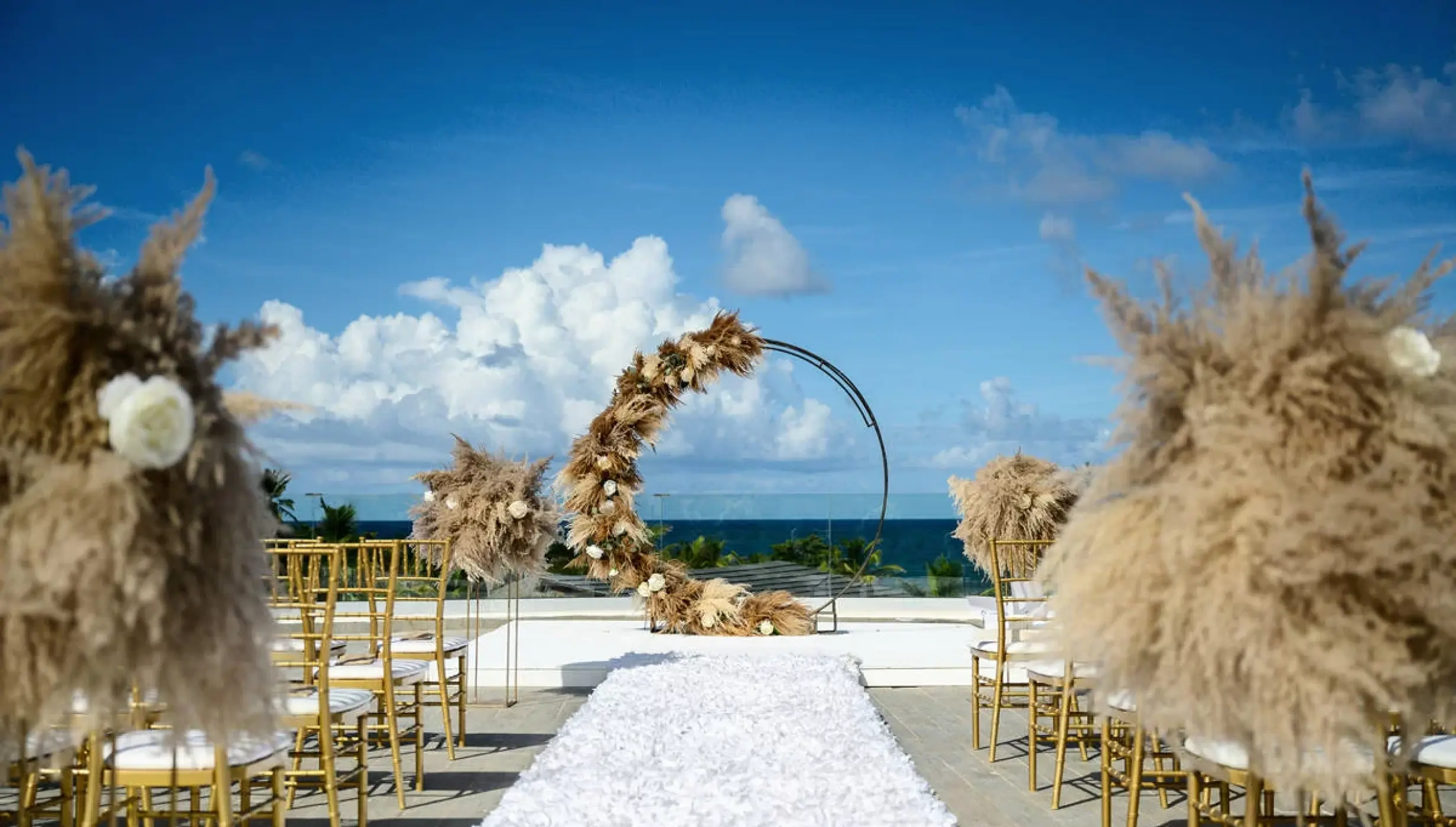 Rooftop wedding ceremony with pampas grass decor and circular arch at Dreams Macao Beach, Punta Cana