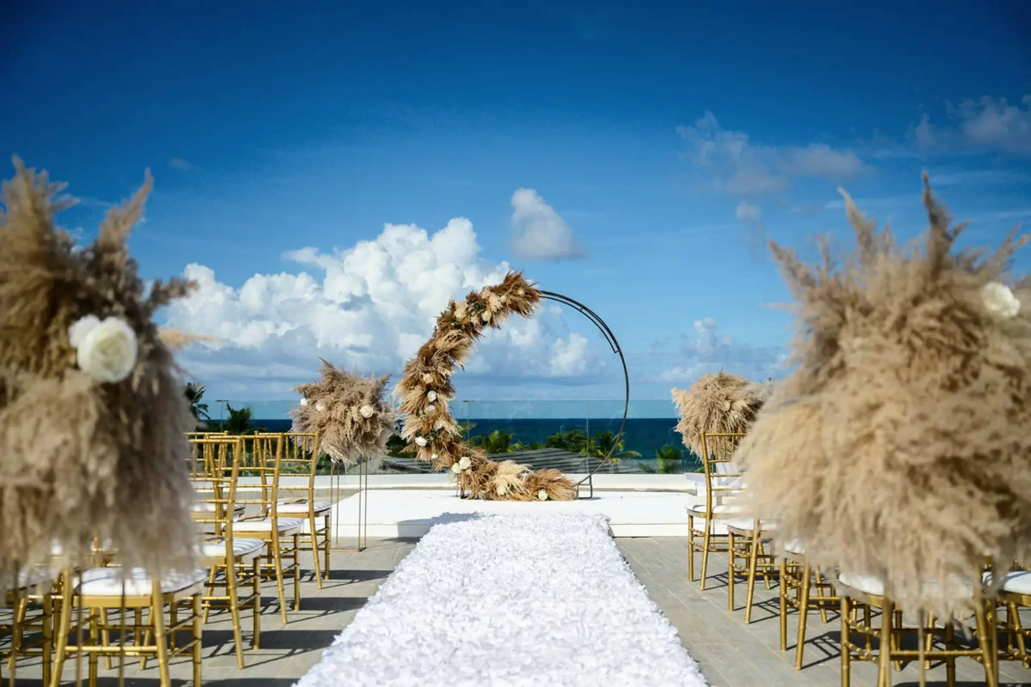 Rooftop wedding ceremony with pampas grass decor and circular arch at Dreams Macao Beach, Punta Cana