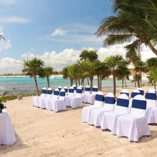 Beach wedding ceremony with white and blue chairs at Barcelo Maya Beach, Riviera Maya