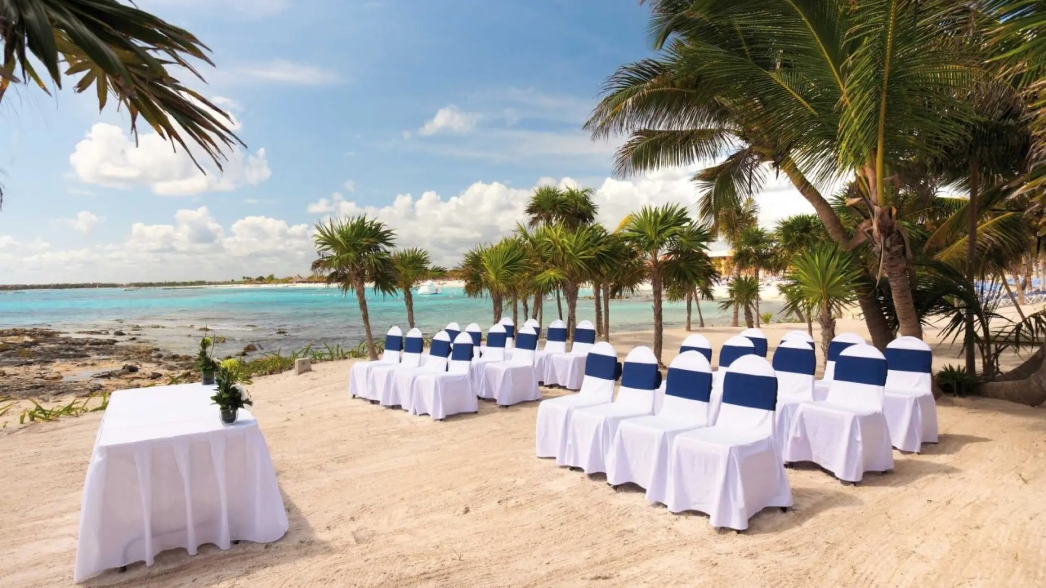 Beach wedding ceremony with white and blue chairs at Barcelo Maya Beach, Riviera Maya