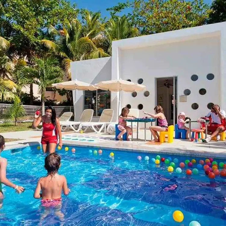 Children playing in the kids club pool at Riu Palace Mexico, Playa Del Carmen