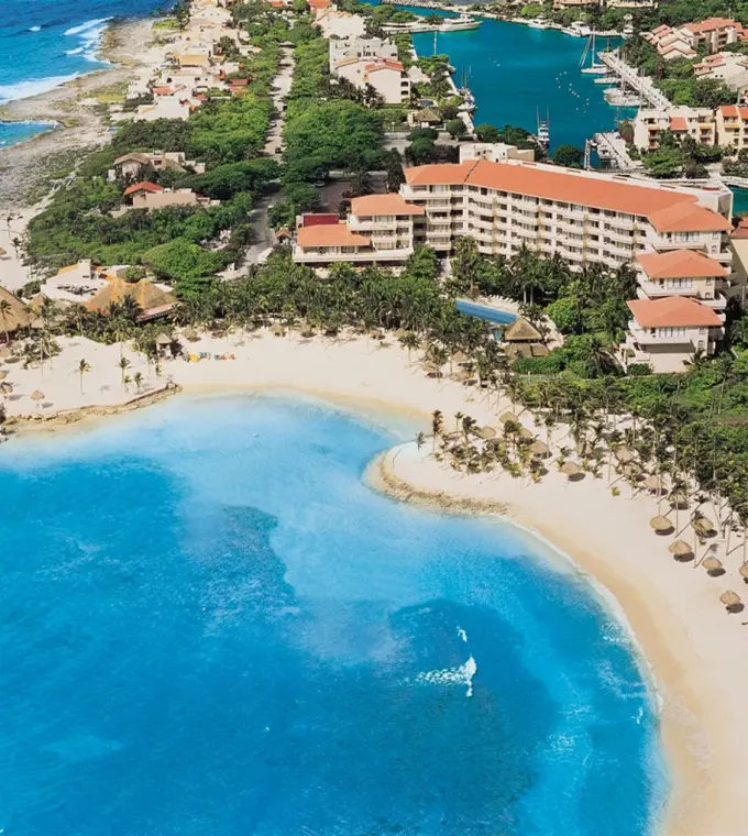 Aerial view of Dreams Aventuras beach and resort buildings on a turquoise bay, Riviera Maya