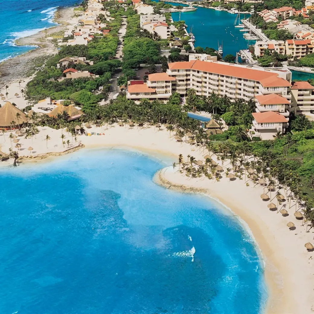 Aerial view of Dreams Aventuras beach and resort buildings on a turquoise bay, Riviera Maya