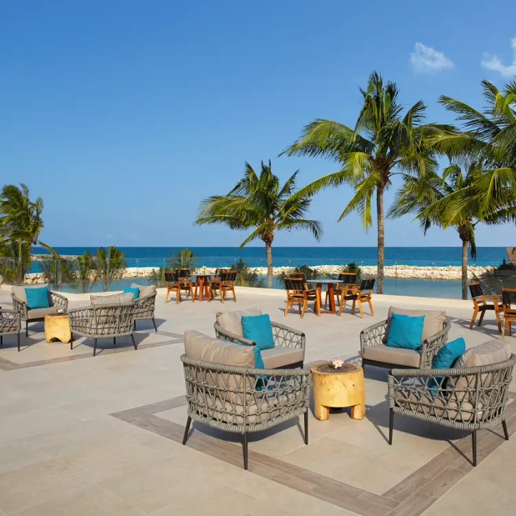 Rooftop terrace with lounge seating and ocean views at Dreams Aventuras, Riviera Maya