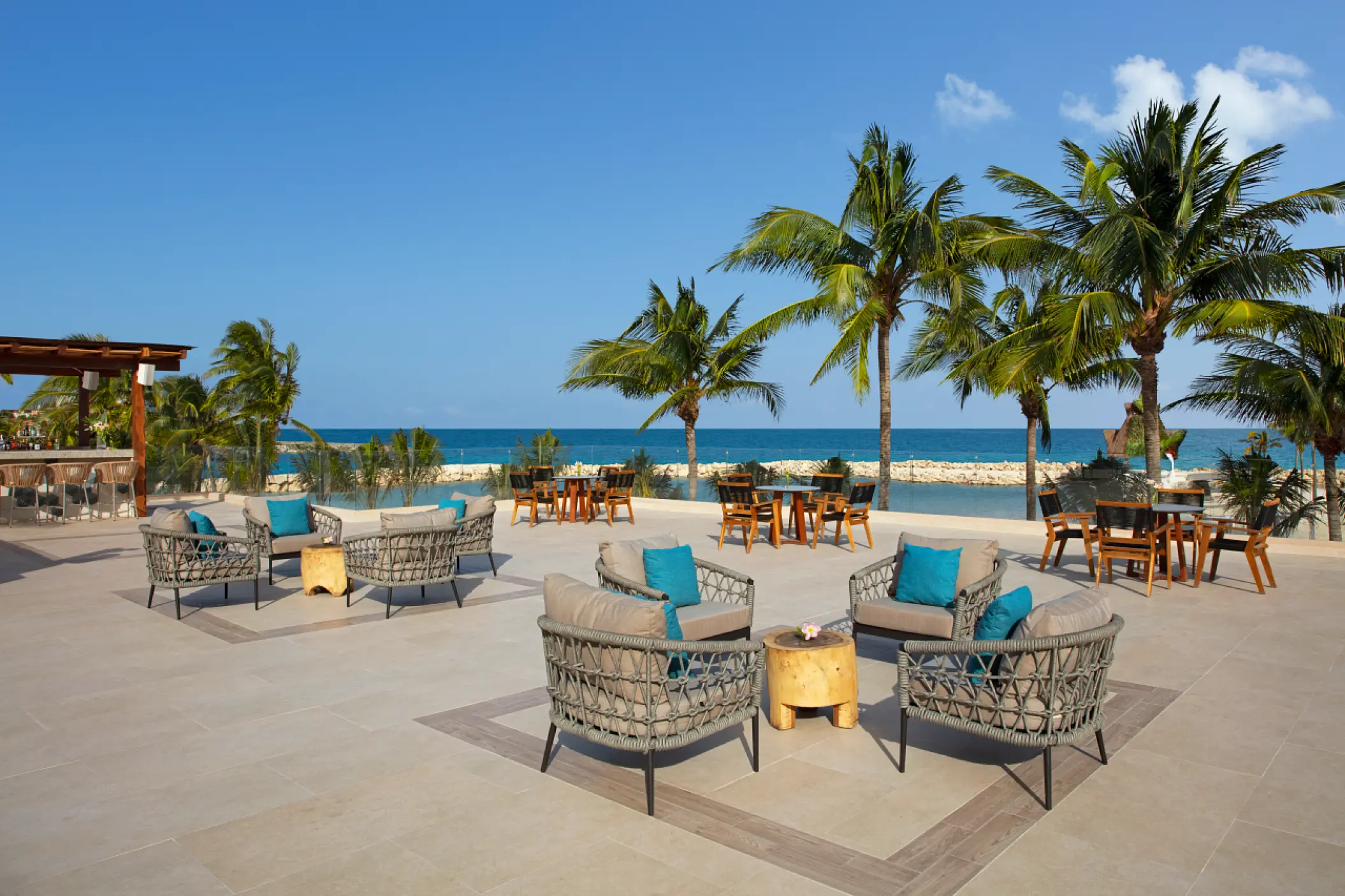 Rooftop terrace with lounge seating and ocean views at Dreams Aventuras, Riviera Maya