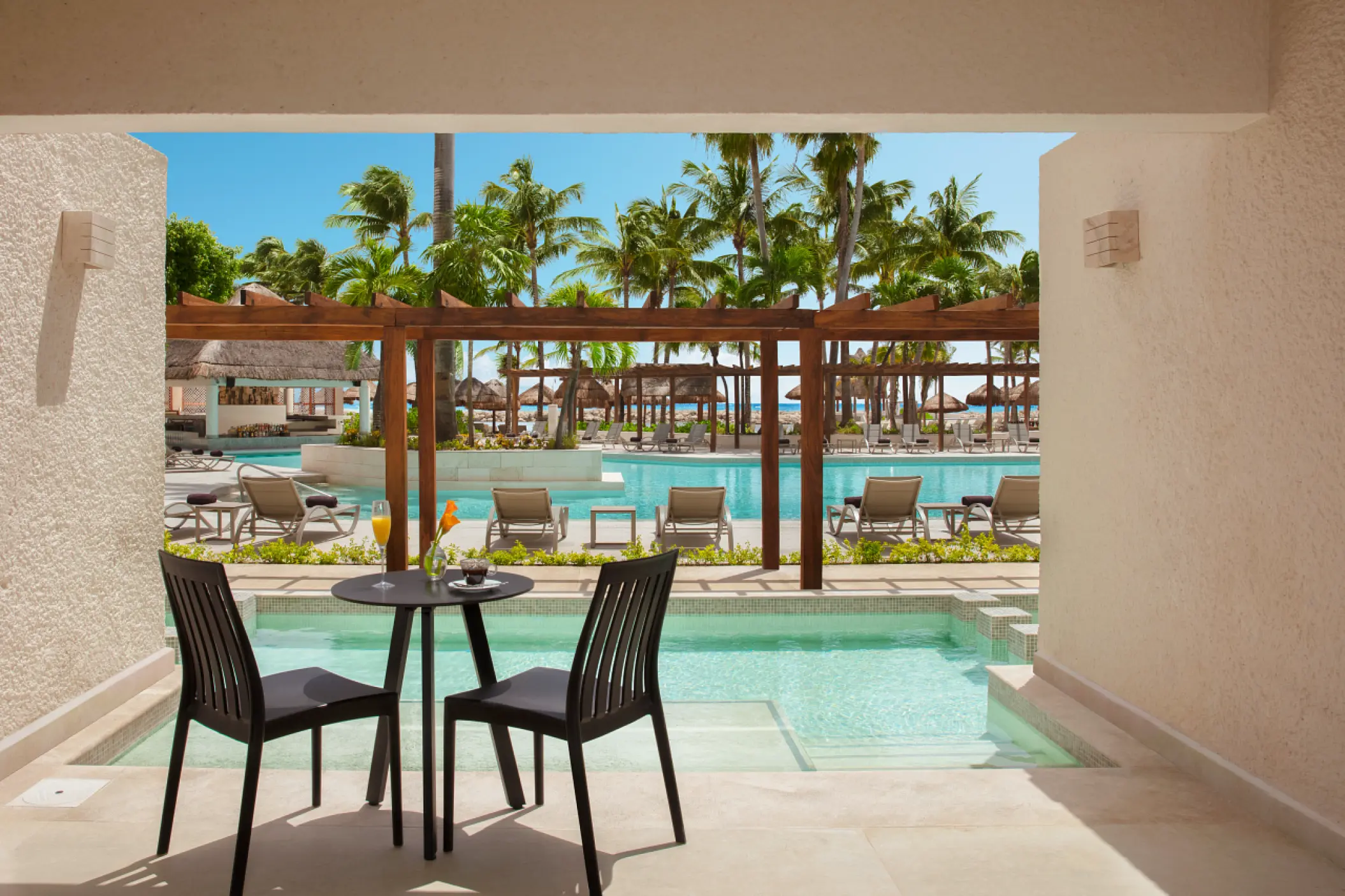 Swim-up suite terrace with seating at Dreams Aventuras, Riviera Maya