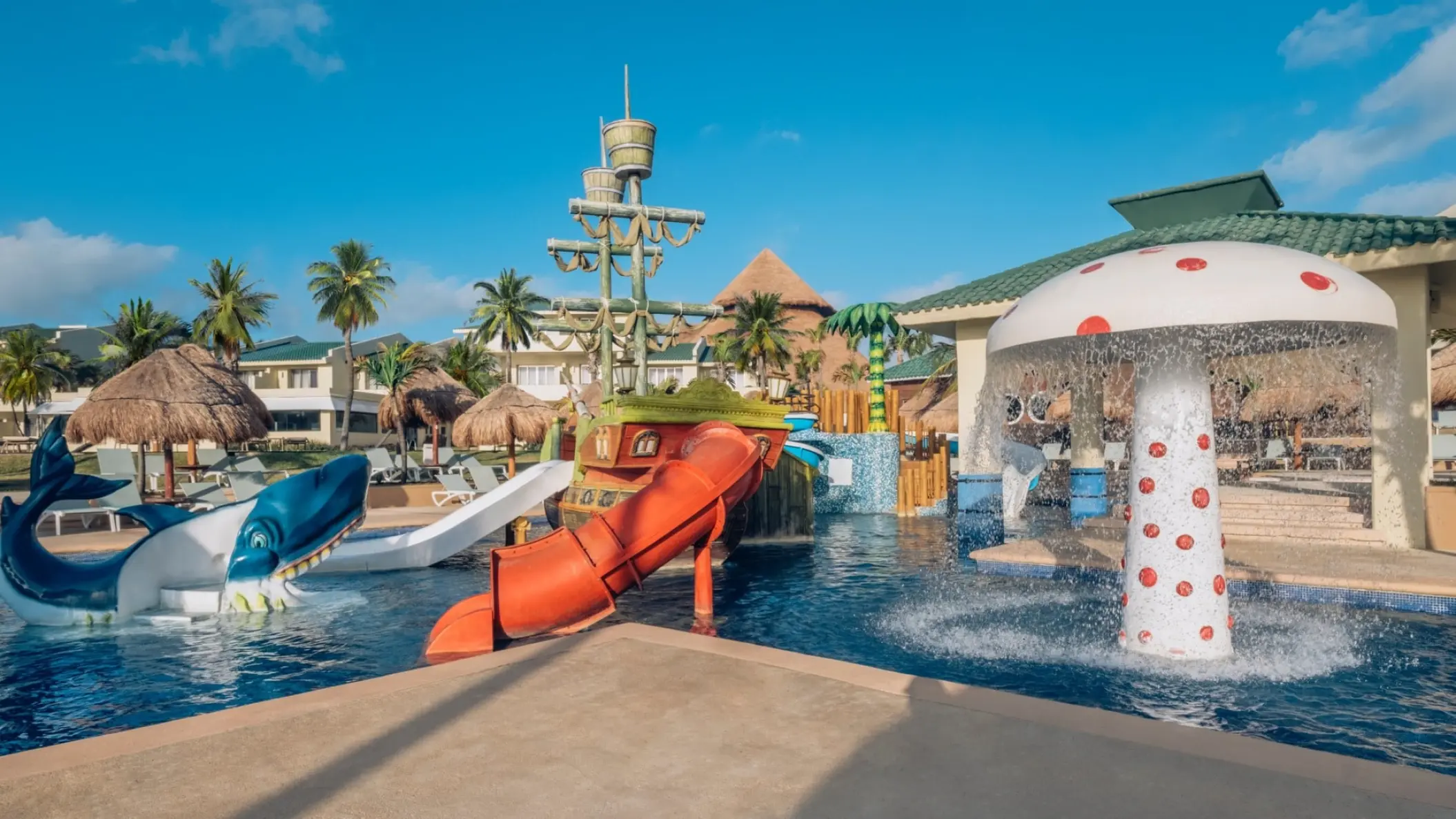 Kids water park with slides and a mushroom fountain at Iberostar Selection Cancun
